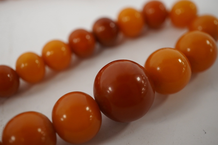 An amber bead necklace, composed of graduated amber beads measuring approximately 15.7-3.6mm, length 58cm, gross weight 23 grams. Condition: overall good, some minor crazing, some minor wear, commensurate with age